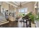 Grand living room with a stone fireplace, piano, large windows, and stylish furnishings at 3384 Homestretch Dr, Carmel, IN 46032