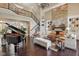 Spacious living room showcasing a grand piano, stone fireplace, and elegant staircase at 3384 Homestretch Dr, Carmel, IN 46032