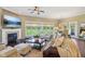 Cozy living area with fireplace, TV, plush seating, and large windows with natural light at 3384 Homestretch Dr, Carmel, IN 46032