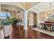 Open floor plan featuring hardwood floors, classic columns, and elegant dining area at 3384 Homestretch Dr, Carmel, IN 46032