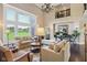 Elegant living room features vaulted ceilings, a grand piano, and a view of a lush, green lawn at 3384 Homestretch Dr, Carmel, IN 46032
