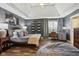 Comfortable main bedroom featuring a tray ceiling, en suite study, and an attractive beanbag chair at 3384 Homestretch Dr, Carmel, IN 46032