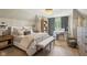 Comfortable main bedroom featuring a striking chandelier and a nearby home office at 3384 Homestretch Dr, Carmel, IN 46032