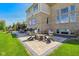 Outdoor patio with a fire pit, comfortable seating, and a lush green lawn at 3384 Homestretch Dr, Carmel, IN 46032