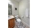 Bright bathroom featuring a glass-enclosed shower, toilet, and a wood vanity with neutral accents at 355 E Ohio St # Ste 105, Indianapolis, IN 46204