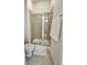 Bathroom features a glass-enclosed shower with tile surround, and a white patterned bath mat at 355 E Ohio St # Ste 105, Indianapolis, IN 46204
