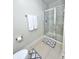 Bathroom featuring a glass-enclosed shower with tile surround, and neutral toned bath mats at 355 E Ohio St # Ste 105, Indianapolis, IN 46204