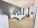 Spacious bedroom with a dark accent wall, light carpet, and a chandelier at 355 E Ohio St # Ste 105, Indianapolis, IN 46204