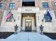 Exterior view of the Hudson building entrance, with American and Indiana flags at 355 E Ohio St # Ste 105, Indianapolis, IN 46204