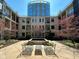 Serene courtyard view with lounge seating, spring blossoms, and a modern fountain at 355 E Ohio St # Ste 105, Indianapolis, IN 46204
