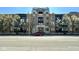 Beautiful brick apartment building with trees in front and a red car parked on the street at 355 E Ohio St # Ste 105, Indianapolis, IN 46204