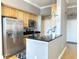 Bright kitchen featuring stainless steel appliances, dark countertop and light-colored cabinets at 355 E Ohio St # Ste 105, Indianapolis, IN 46204