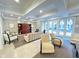 Bright living room with neutral colors and multiple seating options, next to an enclosed patio at 355 E Ohio St # Ste 105, Indianapolis, IN 46204