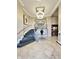 Elegant lobby with marble floors, modern light fixture, staircase, elevator and decorative table arrangement at 355 E Ohio St # Ste 105, Indianapolis, IN 46204