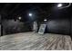 Unfinished basement featuring painted brick walls, a drop ceiling, and vinyl floors at 3628 N Illinois St, Indianapolis, IN 46208