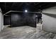 Unfinished basement featuring painted brick walls, a drop ceiling, and vinyl floors at 3628 N Illinois St, Indianapolis, IN 46208