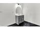 Bathroom with modern gray vanity, beautiful arched mirror, marble floors, and clean aesthetic at 3628 N Illinois St, Indianapolis, IN 46208