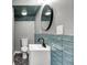 Bathroom with white vanity, blue subway tile, black fixtures, and a marble-look floor at 3628 N Illinois St, Indianapolis, IN 46208