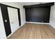 Bedroom with a built in closet, hardwood floors, and contrasting black and white paint at 3628 N Illinois St, Indianapolis, IN 46208