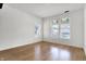 Bright bedroom featuring hardwood floors, white walls, and natural light from two windows at 3628 N Illinois St, Indianapolis, IN 46208