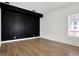 Bedroom with a built in closet, hardwood floors, contrasting black and white paint, and window at 3628 N Illinois St, Indianapolis, IN 46208