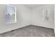 This bedroom features neutral walls, gray carpet, and bright light from two windows at 3628 N Illinois St, Indianapolis, IN 46208
