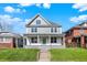 Charming two-story home featuring a covered front porch and freshly cut green lawn at 3628 N Illinois St, Indianapolis, IN 46208
