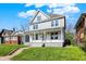 Charming two-story home with a well-maintained lawn and a covered front porch at 3628 N Illinois St, Indianapolis, IN 46208