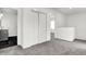 Bright hallway with closet doors, chevron accent wall, and neutral carpet throughout the home at 3628 N Illinois St, Indianapolis, IN 46208