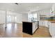 Spacious kitchen with a black island and modern cabinets, wood floors, and an open-concept layout at 3628 N Illinois St, Indianapolis, IN 46208