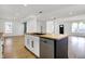Modern kitchen island with butcher block countertop, stainless steel appliances, and open layout to the living area at 3628 N Illinois St, Indianapolis, IN 46208