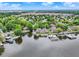 Panoramic aerial view showcasing the lakefront homes, private docks, and lush green surroundings at 3646 Beach Blvd, Cicero, IN 46034