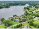 An aerial view of a serene lake surrounded by lush green trees, featuring waterfront homes with private docks at 3646 Beach Blvd, Cicero, IN 46034
