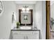 Charming bathroom with granite countertop, wooden-framed mirror and classic white cabinets at 3646 Beach Blvd, Cicero, IN 46034