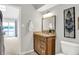 This remodeled bathroom has a wood vanity, framed mirror and natural lighting at 3646 Beach Blvd, Cicero, IN 46034