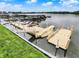 A plastic dock on a lake with a ramp to a small boat and a grassy bank at 3646 Beach Blvd, Cicero, IN 46034