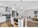 Kitchen with stainless steel appliances and island. Living room with sofa, rug, and stairs in the background at 3646 Beach Blvd, Cicero, IN 46034