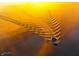 Aerial view of a motorboat gliding over a golden lake, creating mesmerizing ripples at 3646 Beach Blvd, Cicero, IN 46034