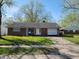 A charming single-story brick home featuring a well-manicured lawn and an attached single-car garage at 3755 N Brentwood Ave, Indianapolis, IN 46235