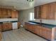 Kitchen featuring wood cabinets, countertops, tiled flooring and a window offering natural light at 3755 N Brentwood Ave, Indianapolis, IN 46235