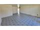 A spacious empty living room features patterned tile flooring, blank walls, and natural light at 3755 N Brentwood Ave, Indianapolis, IN 46235