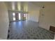Spacious living room featuring tile flooring, natural light from boarded windows and an open layout at 3755 N Brentwood Ave, Indianapolis, IN 46235