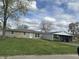 Exterior view of home showing a well-kept lawn and metal carport at 3883 N 150 W, Columbus, IN 47201