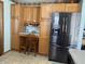 Eat-in kitchen features wood cabinets, a built-in desk, and a stainless steel refrigerator at 3883 N 150 W, Columbus, IN 47201