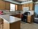 Efficient kitchen layout featuring oak cabinets, a breakfast bar, and modern appliances at 3883 N 150 W, Columbus, IN 47201