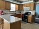 Efficient kitchen layout featuring oak cabinets, a breakfast bar, and modern appliances at 3883 N 150 W, Columbus, IN 47201