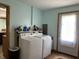 Well-lit laundry room featuring modern appliances and an exterior door for easy access at 3883 N 150 W, Columbus, IN 47201