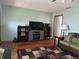 Comfortable living room with entertainment center, dark wood shelves, and an area rug at 3883 N 150 W, Columbus, IN 47201