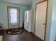 Functional mud room with durable wood floors, white refrigerator, and an exterior door at 3883 N 150 W, Columbus, IN 47201