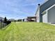 Spacious backyard featuring a covered patio, basketball court, and ample green space for activities at 4205 Hunt Club Pkwy, Bargersville, IN 46106